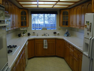 oak cabinets and white tile in kitchenn